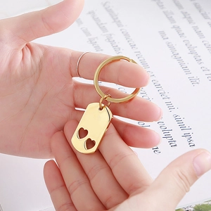 Close-up of golden stainless steel rectangular keychain with heart-shaped cutouts