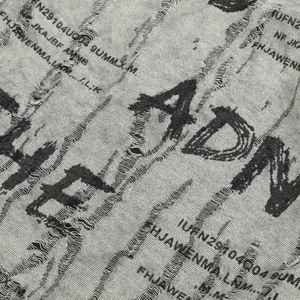 Close-up of grey knit fabric with distressed street style letter printing and texture