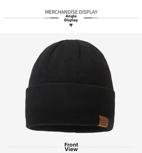 Front view of black ribbed knit beanie with brown leather Classic Sport patch detail