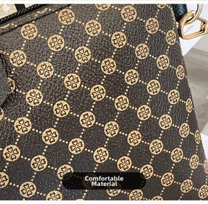 Macro detail of textured synthetic leather with vintage clover patterns and golden metal hardware