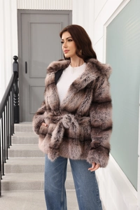 Close-up of brown faux fur coat featuring a belted waist and luxury hood detail