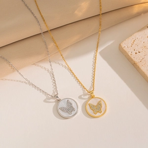 Elegant gold and silver butterfly mother of pearl necklaces on a natural stone base