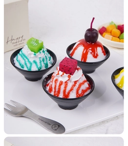 Macro detail of artificial fruit ice bowl models featuring kiwi and cherry toppings