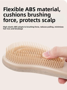 Macro shot showing the flexible ABS material and cushioning structure of the detangling brush