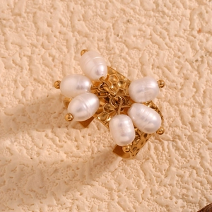Detail of 18K gold plated hammered texture ring with hanging white pearls