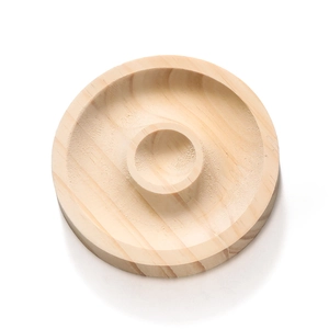 Macro shot of circular wooden bead design tray with natural texture and scale grooves