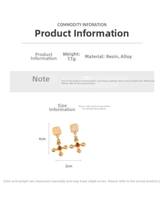 Detail view of gold cross earrings with brown resin beads, 4cm size and 7.1g weight