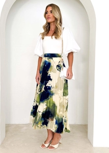 Detail of elegant pleated skirt with abstract oil painting print and light fabric