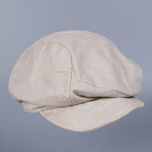 Close-up of the breathable linen texture and stitching on this beige newsboy cap