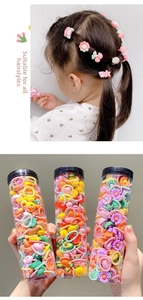 Variety pack of colorful children's hair accessories in tubes with cute fruit and flower charms