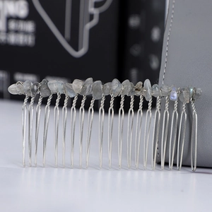 Macro shot of silver hair comb with handmade blue natural stone crystal wire wrapping