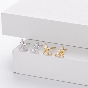 Detail view of silver and gold flower stud earrings with marquise-cut cubic zirconia