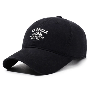 Vintage black washed cotton baseball cap with white mountain embroidery in a side-profile view