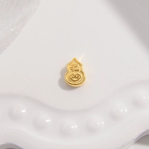 Macro shot of gold S925 silver gourd bead with Fu character and auspicious clouds