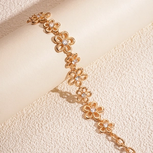 Close-up of vintage gold flower bracelet with zircon center and spiral texture detail