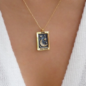 Detail of 18K gold tarot moon pendant with paperclip chain on a model neck