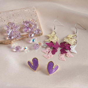 Detail of 6-piece earring set featuring purple flowers, butterflies, and drip oil hearts