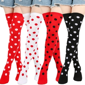 Detailed view of over-the-knee polka dot socks in red, white and black festival colors