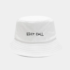 Close-up of white cotton bucket hat with black NIGHT CALL graffiti style embroidery