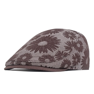 Detail of daisy jacquard weaving texture on brown denim flat cap with piping brim