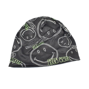 Black beanie with graffiti smileys and green The Sun lettering in a stylish slouchy fit