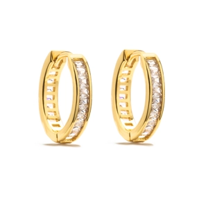 Macro shot of 18K gold huggie hoop earrings featuring channel-set baguette-cut cubic zirconia
