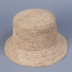 Handcrafted beige raffia sun hat for women with fine crochet weave and bucket style
