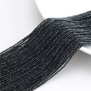 Close-up of black faceted crystal glass beads showing detailed cut and glossy shine