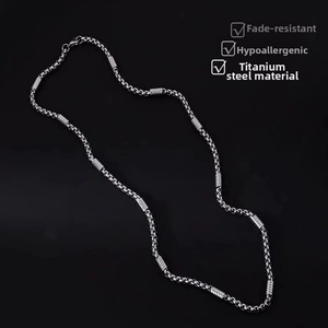 Close-up of hip-hop silver tone titanium steel square pearl stick chain necklace