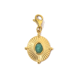 Detail of sunburst gold pendant featuring a green stone and functional lobster clasp