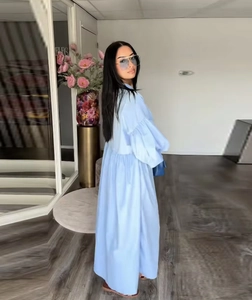 Detail view of sky blue long sleeve smock dress with pleated cuffs and high waist design