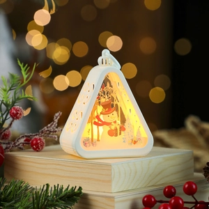Detail of a white Christmas lantern with warm light and snowman scene on wood table