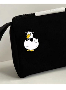 Detail of creative gentleman duck enamel pin with top hat on a black fabric bag