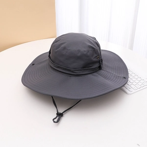 Close-up of grey wide brim hiking hat with adjustable wind cord and metal vent holes