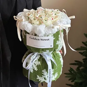 Christmas bouquet with lamb wool wrap and spotted white roses in festive holiday style