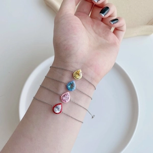 Detail of colorful enamel drip oil sterling silver bracelets with zircon drop charms