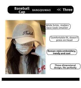 Close-up of Nashville cursive embroidery on wide-brim beige cotton baseball cap