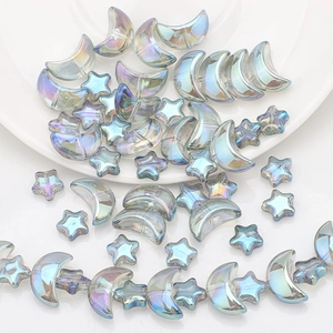 Macro detail of iridescent moon and star glass beads for DIY jewelry making