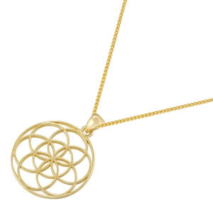 Macro shot of gold hollow circular pendant with life tree pattern on white background