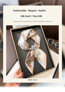 Close-up of silk scarf with vintage European architecture print in a gift box