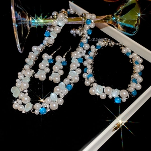 Exquisite jewelry set featuring silver necklace, bracelet and earrings with oval pearls