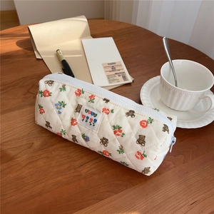 Detail of quilted cotton pencil case with floral bear pattern and fabric label