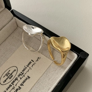 S925 sterling silver irregular liquid metal rings in gold and silver on a jewelry box