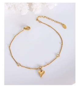 Close-up of 18k gold plated heart anklet with sparkling zircon stones and lobster clasp