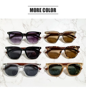 Detailed flat lay of square sunglasses in six diverse colors on a white marble surface
