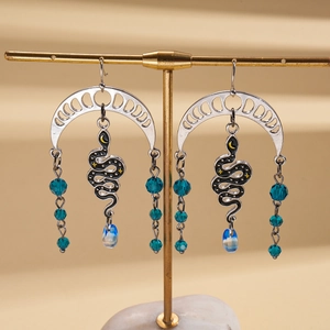 Snake tassel earrings with blue beads and crescent moon motifs in bohemian style