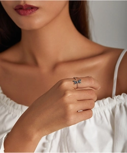 Detail of blue dragonfly ring on hand showing the open adjustable S925 silver band