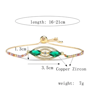 Detailed view of adjustable gold plated heart bracelet with green and colorful zircons