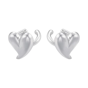 Close-up of polished silver heart-shaped ear cuffs with a minimalist 3D curved design