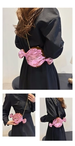 Pink candy-shaped crossbody bag with metallic finish and gold chain strap detail